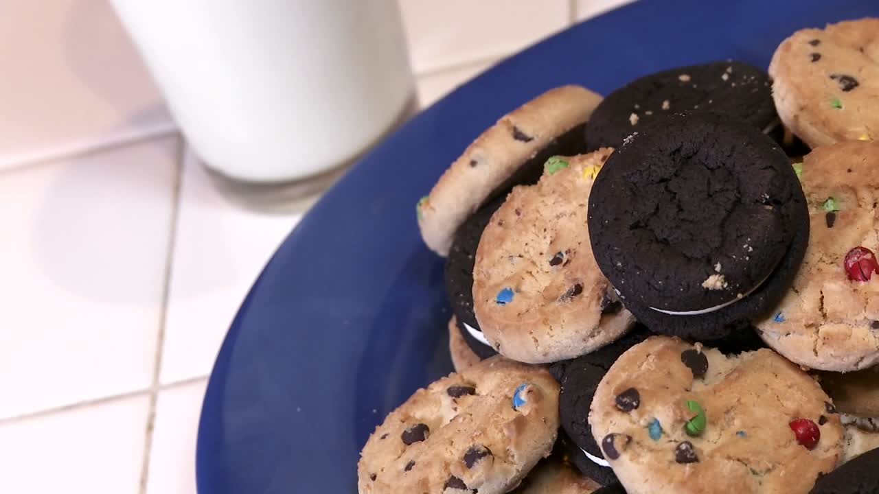 A Plate Full Of Cookies With A Glass Of Milk