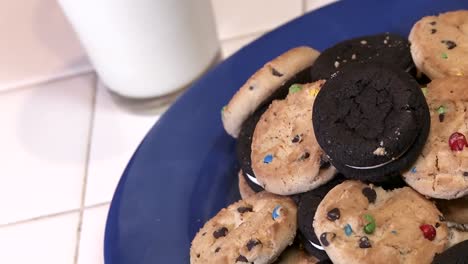 a plate full of cookies with a glass of milk