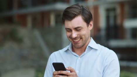 closeup businessman using smartphone at street. man typing on phone outside