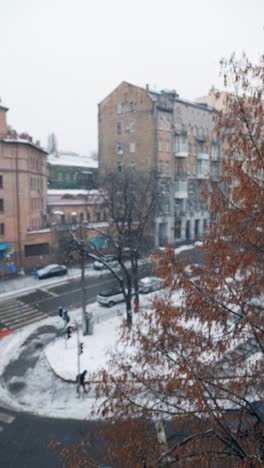 snowy cityscape view from a window