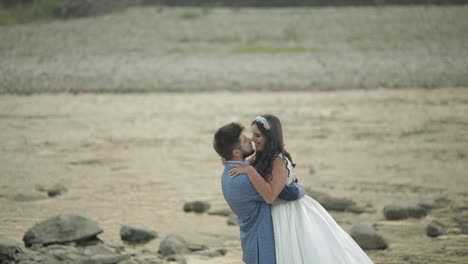 Wedding-couple-standing-near-mountain-river.-Groom-and-bride-in-love