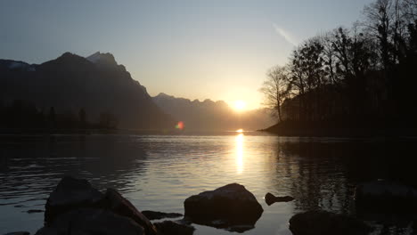 sunset view of walensee in switzerland with mountains and calm waters