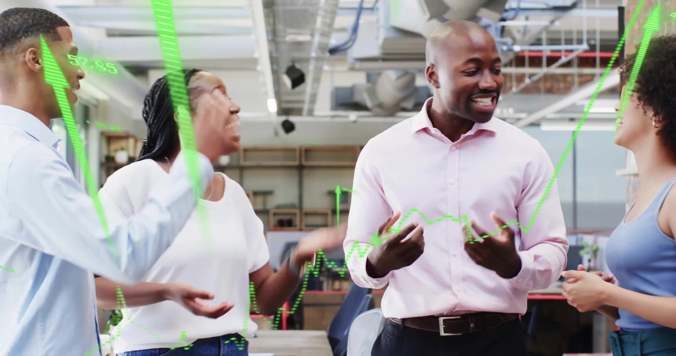 Team of four speaking in open-plan office sparking green chart overlay celebrating sales growth