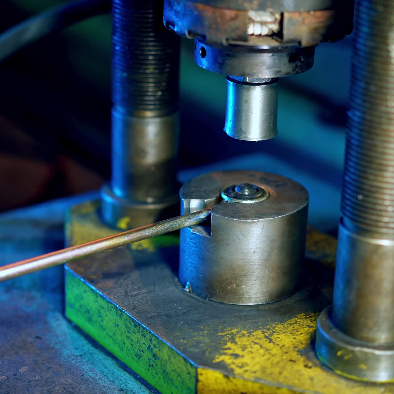 Industrial worker on metal press machine