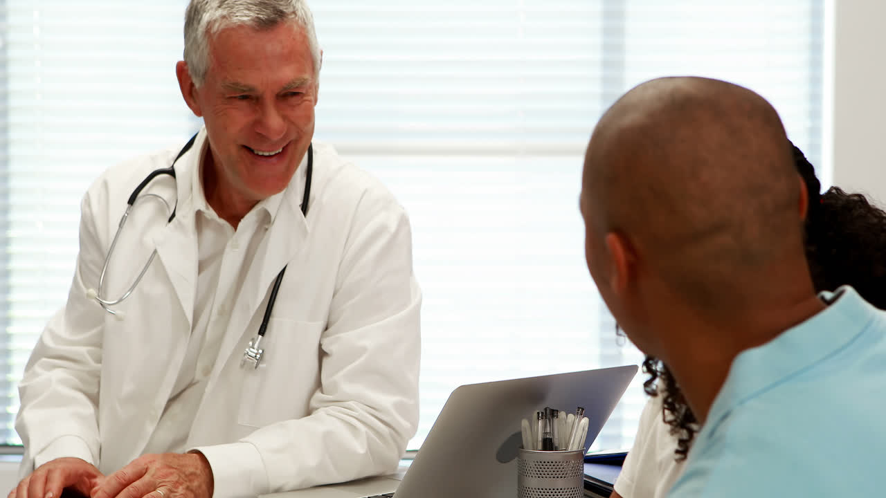Male doctor and patient interacting with each other