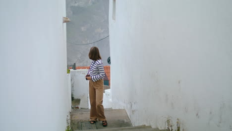 traveler walk narrow street stairs in trip vertical. beautiful girl explore town