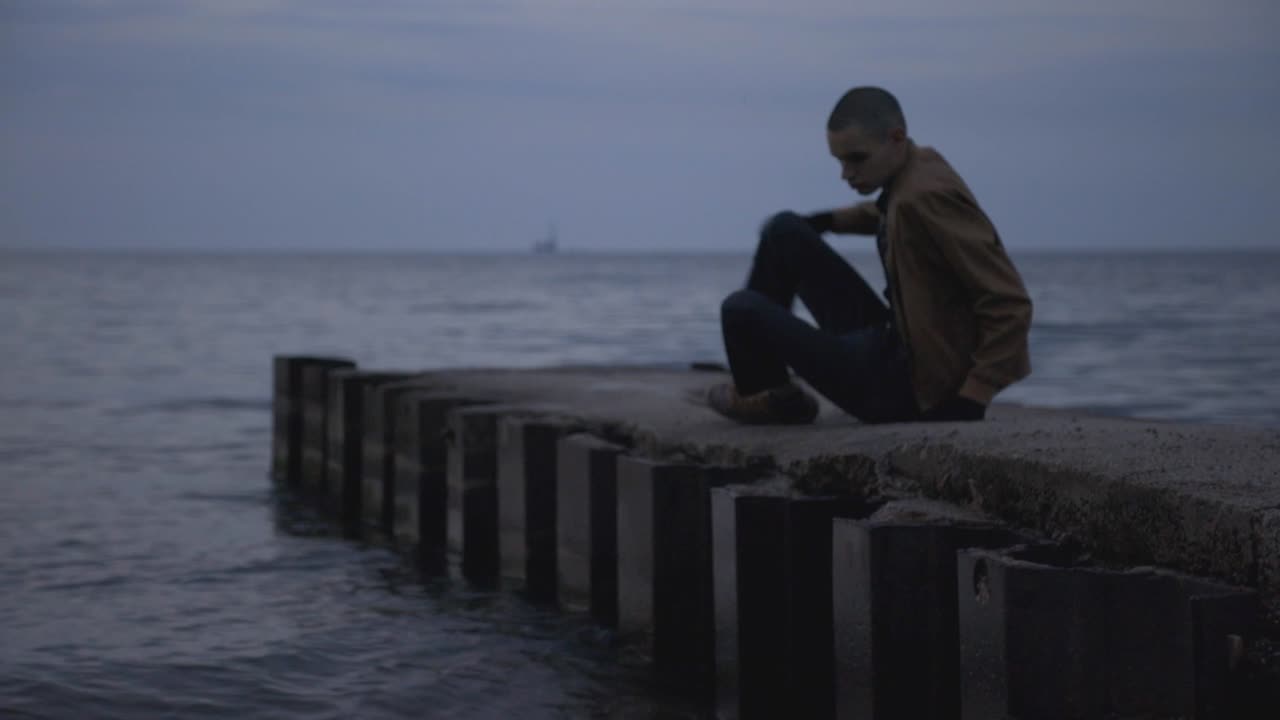 A Lonely Man With Camera Stand And Leaving On The Sea - Wide Shot