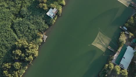 Aerial-view-of-fishing-huts-in-the-river,-Lido-di-Dante,-Fiumi-Uniti,-Ravenna-near-Comacchio-valley