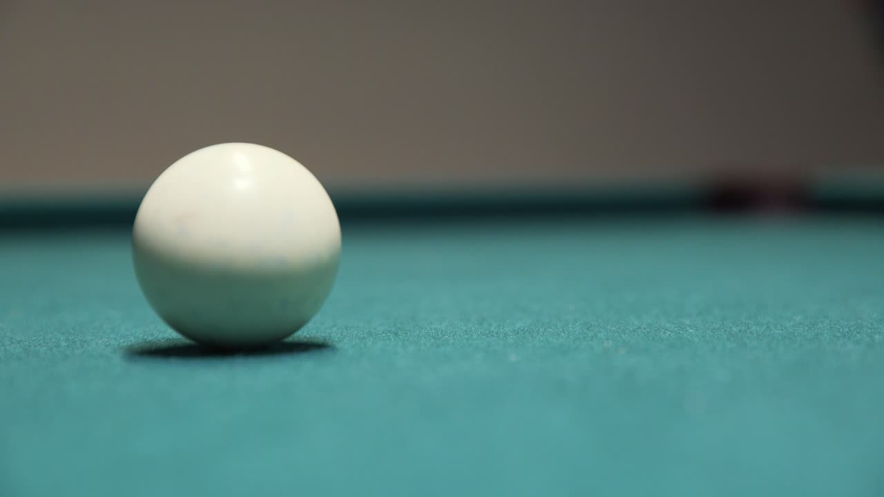 Sinking the black 8-ball to win a game of billiards