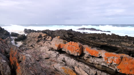 angry ocean breakers smash into rocky shore at storms river mouth, garden route