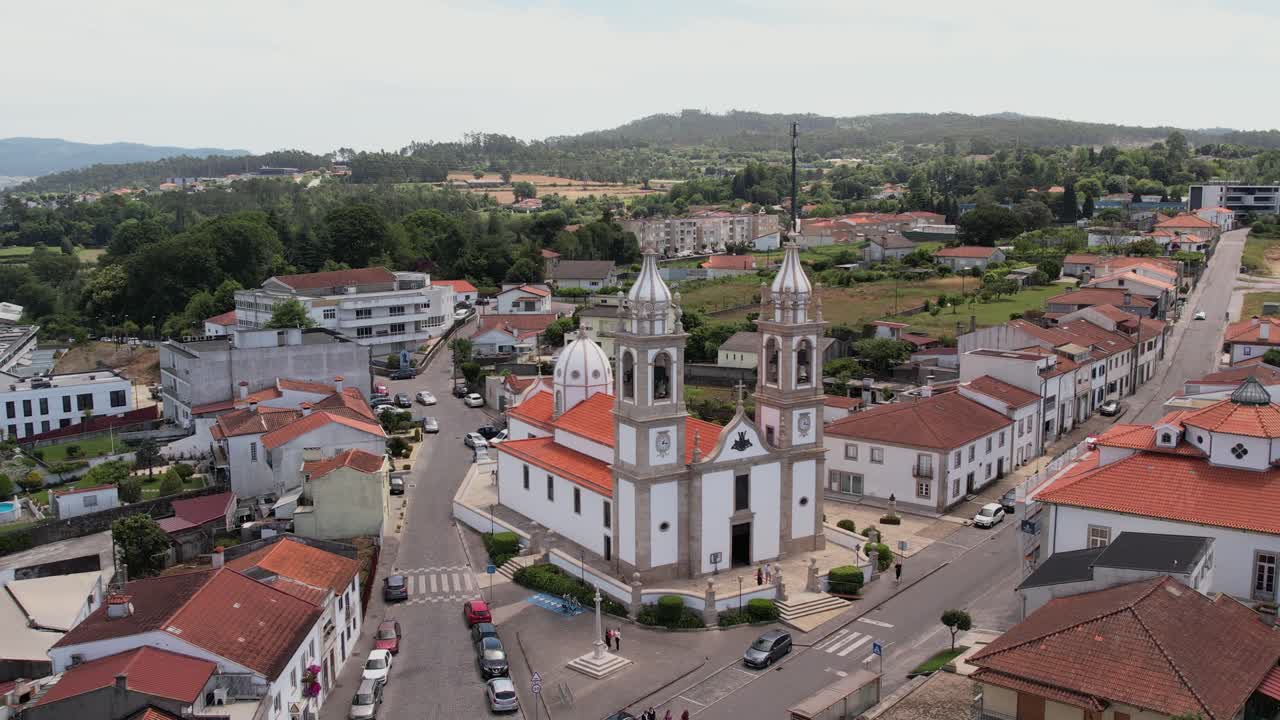 church with twin bell towers at village crossroads in Barcelinhos Portugal