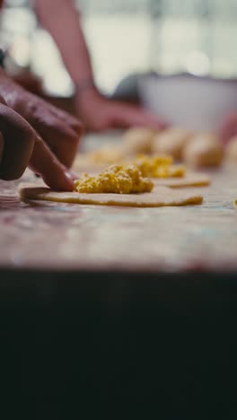 woman preparing empanadas on a table