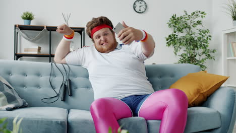 funny friends taking selfies while working out on sofa