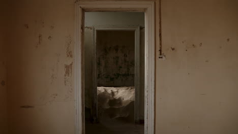 abandoned interior with sand-filled room