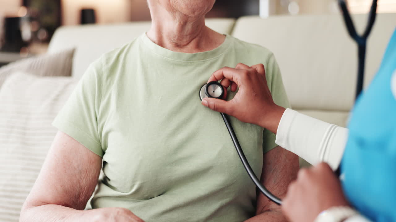 Healthcare Professional Using Stethoscope on Senior Woman's Chest