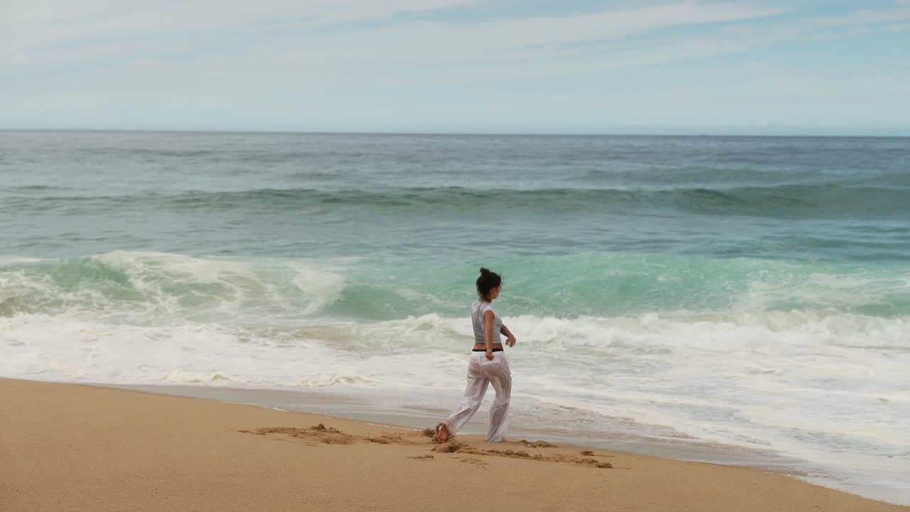 Woman on a sandy beach by the ocean