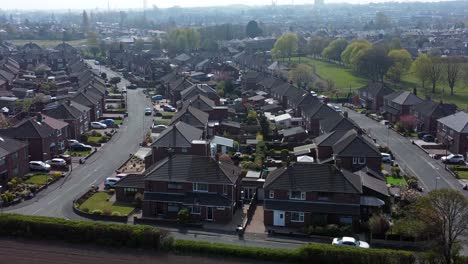 countryside housing estate aerial view flying above rural england farmland residential community homes