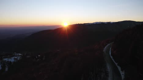 aerial view of beautiful golden sunset over dolomites mountain road