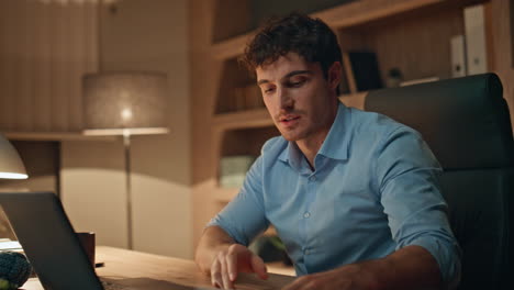 online tutor greeting laptop camera having remote lesson in evening home closeup