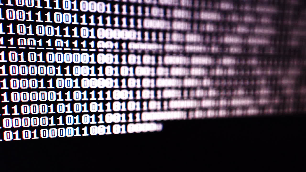 Binary code on the monitor screen. Shooting of a binary code, background