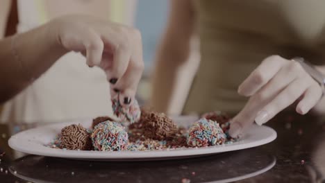 people preparing and enjoying sweet brigadeiros