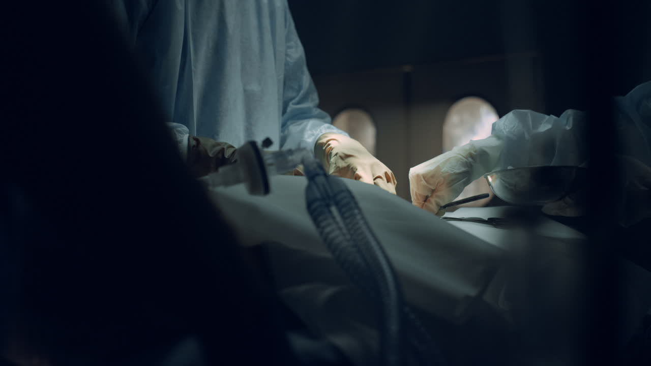 Medical team hands performing operation using sterile surgical tools close up.