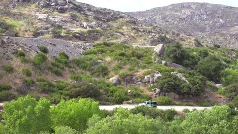 Border-patrol-vehicle-moves-slowly-near-a-railroad-trestle-on-the-US-Mexico-border