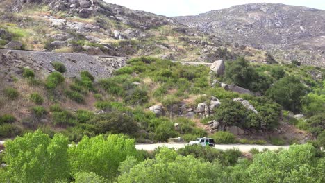 border patrol vehicle moves slowly near a railroad trestle on the us mexico border
