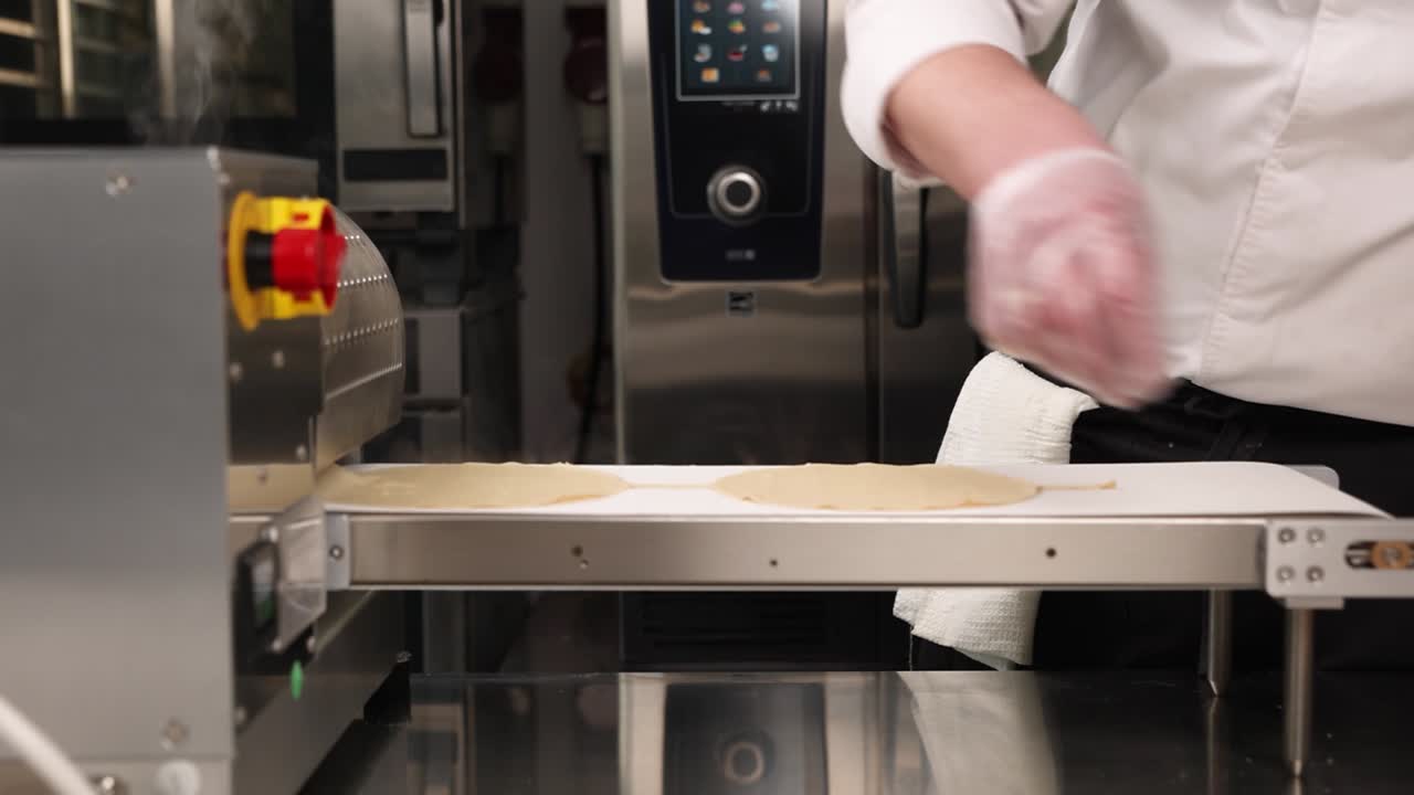 Chef using a dough rolling machine