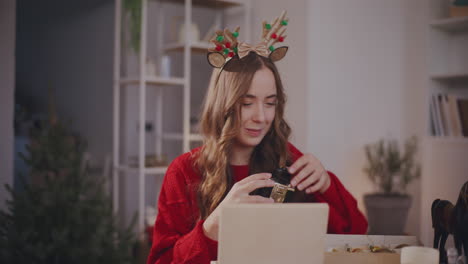 Woman-removing-Christmas-decoration-from-box