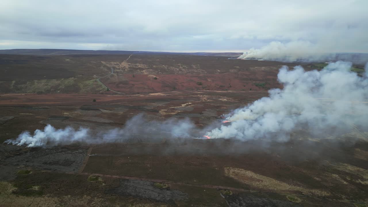 Controlled burning of heather moorland in the North York Moors, low level drone.