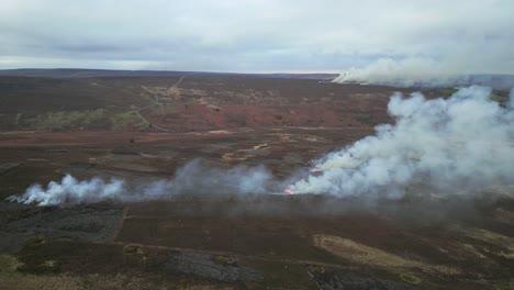 controlled burning of heather moorland in the north york moors, low level drone.