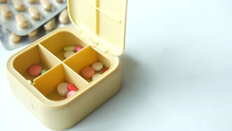 Close-up-of-medical-pills-in-a-pill-box-on-table