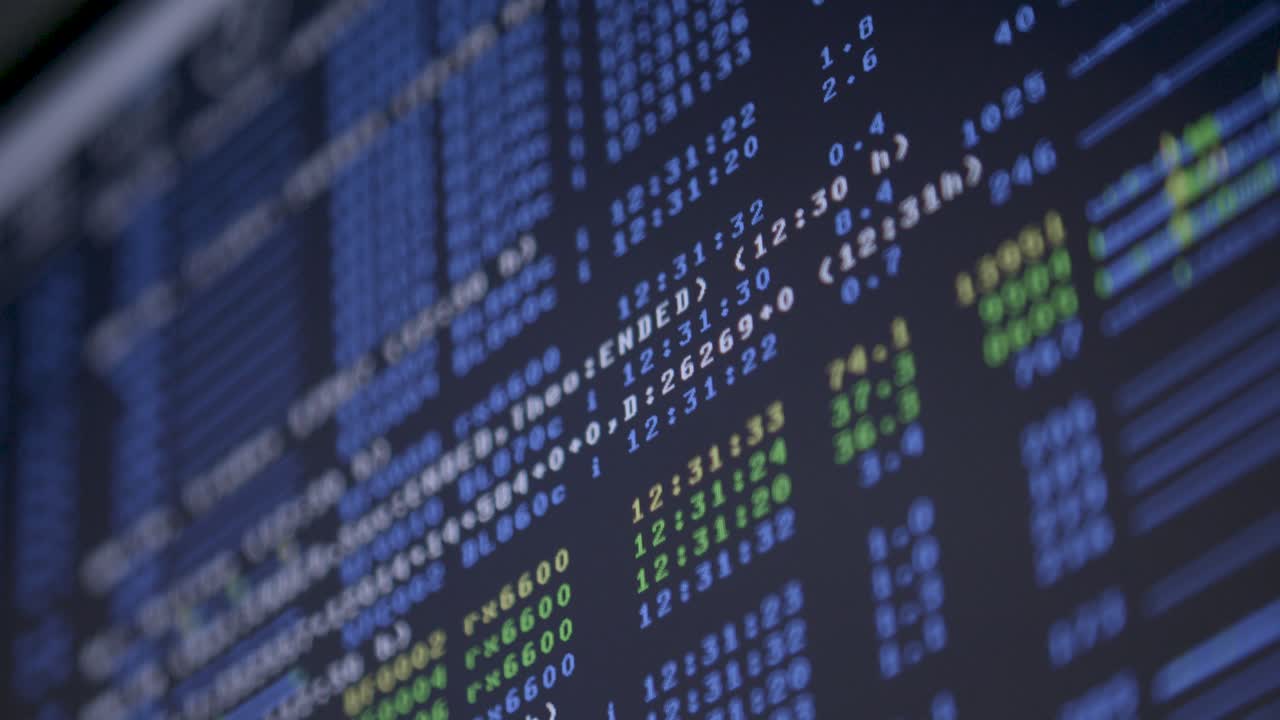 Close-up of computer screen displaying code with a rack focus technique shifting attention