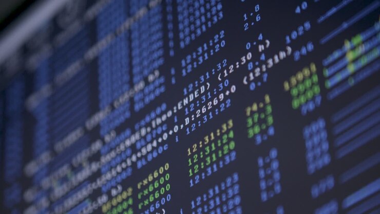 Close-up of computer screen displaying code with a rack focus technique shifting attention