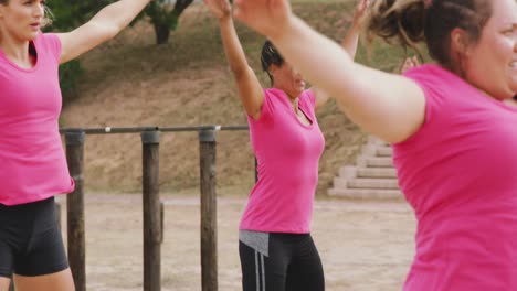 female friends enjoying exercising at boot camp together