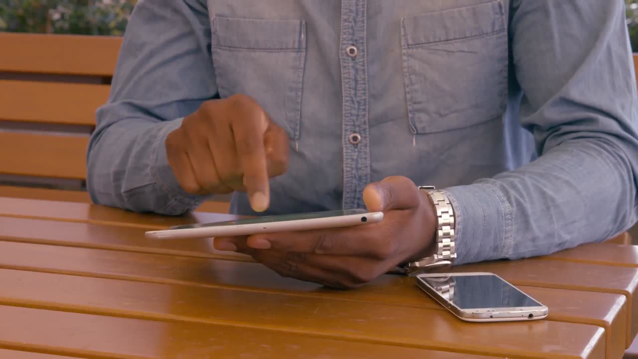 Mans hands using tablet