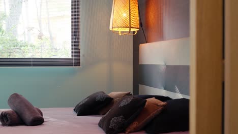 slow revealing shot of a freshly made bed with towels for guests in st gely du fresc
