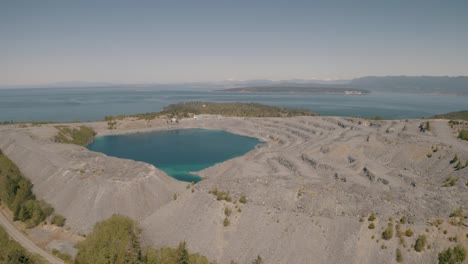aerial view of a quarry lake near the ocean