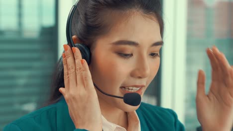 Businesswoman-wearing-headset-working-actively-in-office