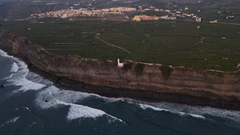 cliffs with banana plantation fields and solidified lava in sea after volcano eruption at la palma