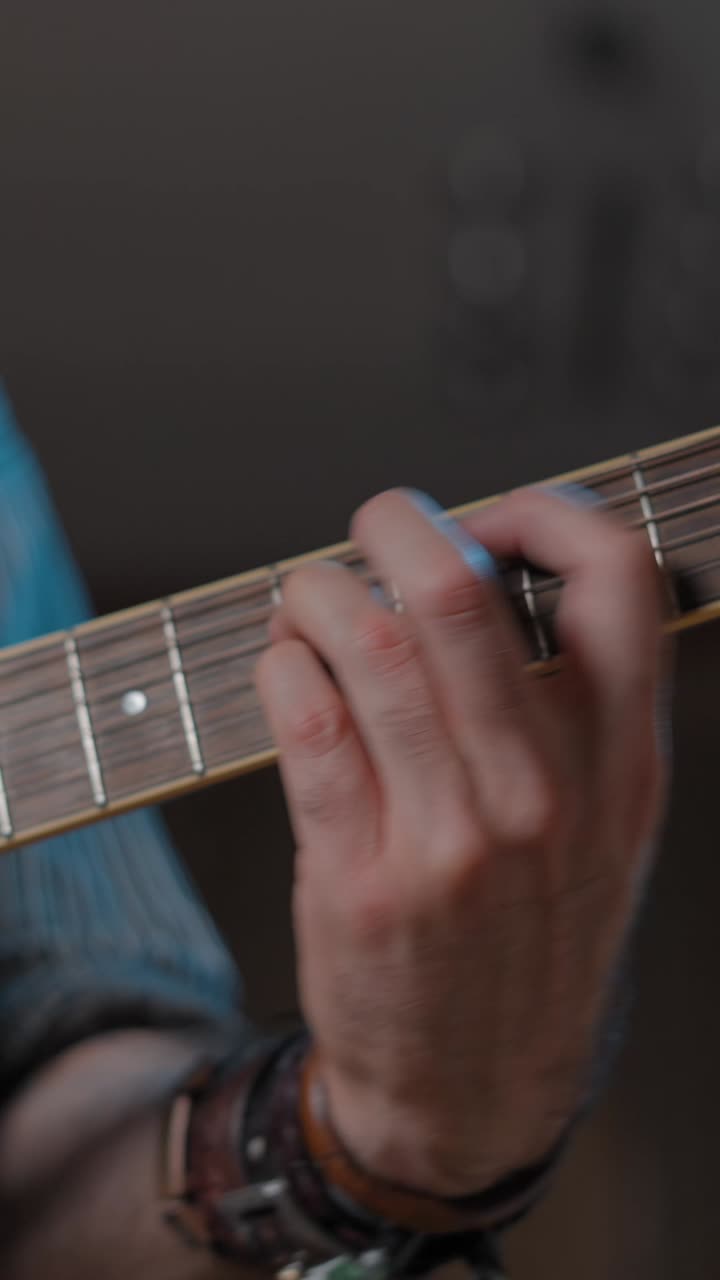 Close-up of a hand playing a guitar