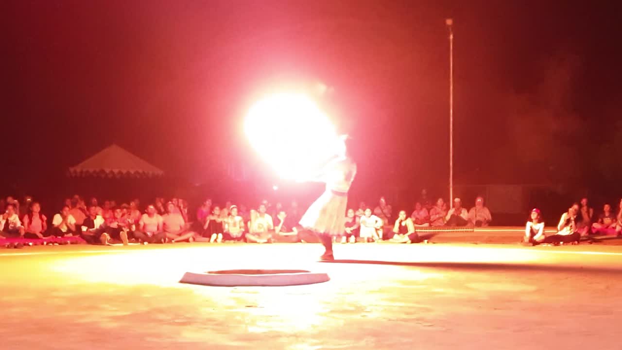 male Kalbeliya dancer in traditional tribal dress performing fire dance near Thar Desert Jaisalmer.