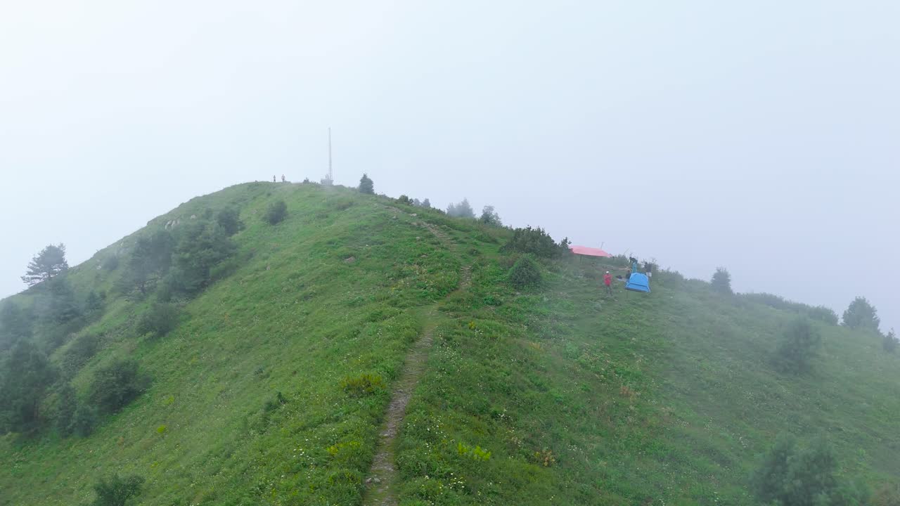 Misty Drone Flight Over Miranjani Peak Engulfed in Dense Clouds