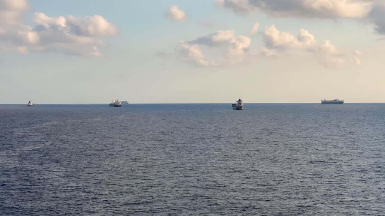 Cargo ship parked parked in the middle of the ocean moving view