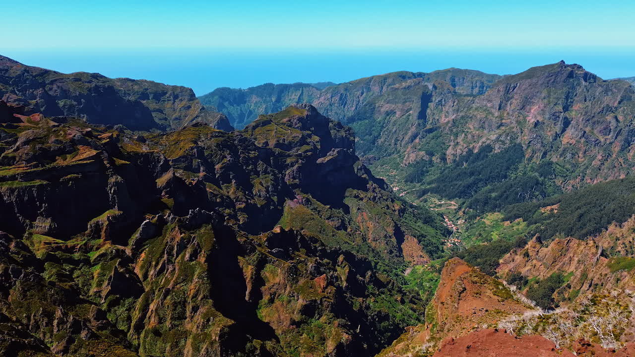 Mountainous landscape with greenery at the foot. Aerial perspective on the rocks of Madeira, Portugal.