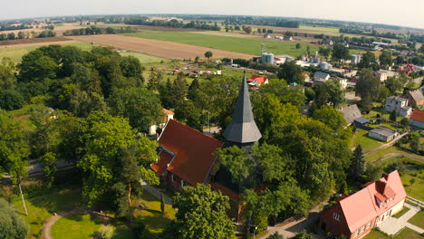 aerial shot, flying around beautiful medieval church in trutnowy, poland