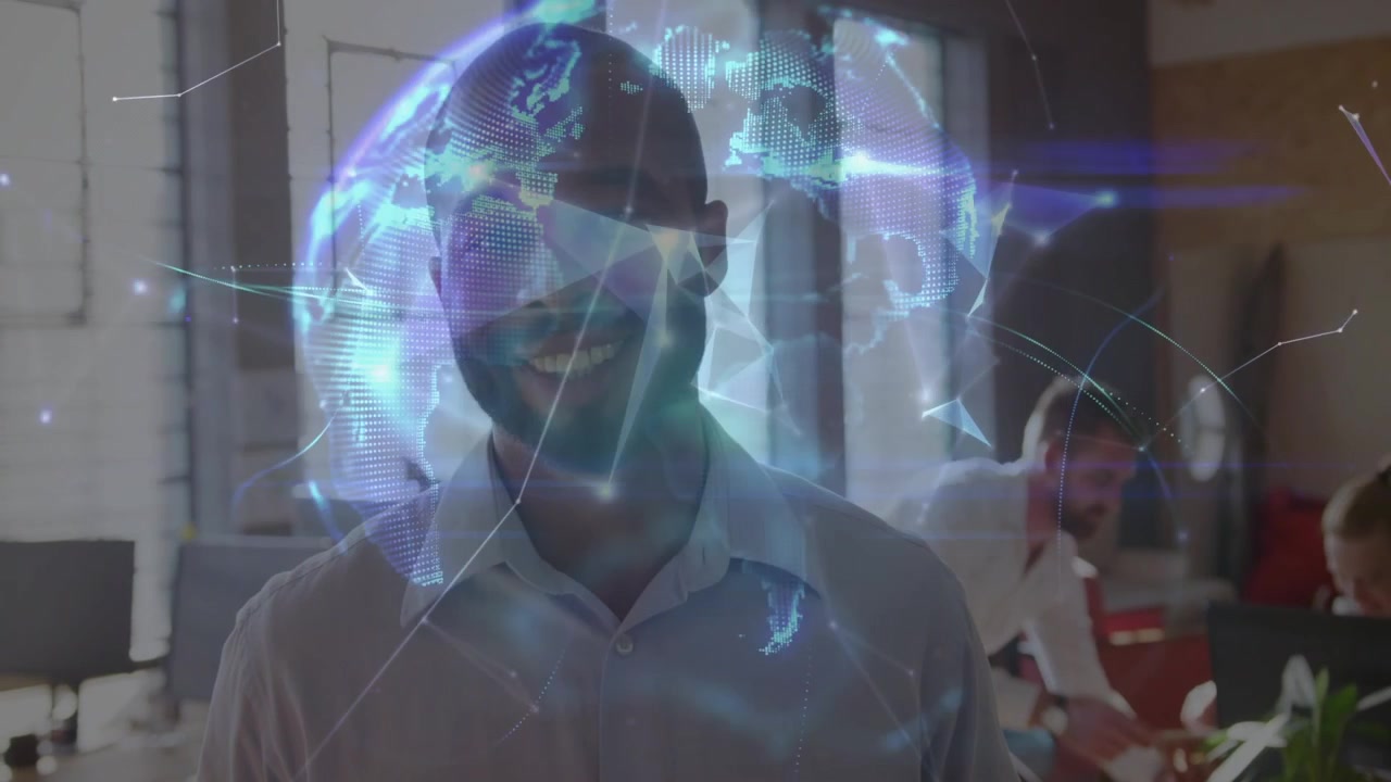 Man standing smiling in office while grid nodes appearing forming rotating globe showing tech data