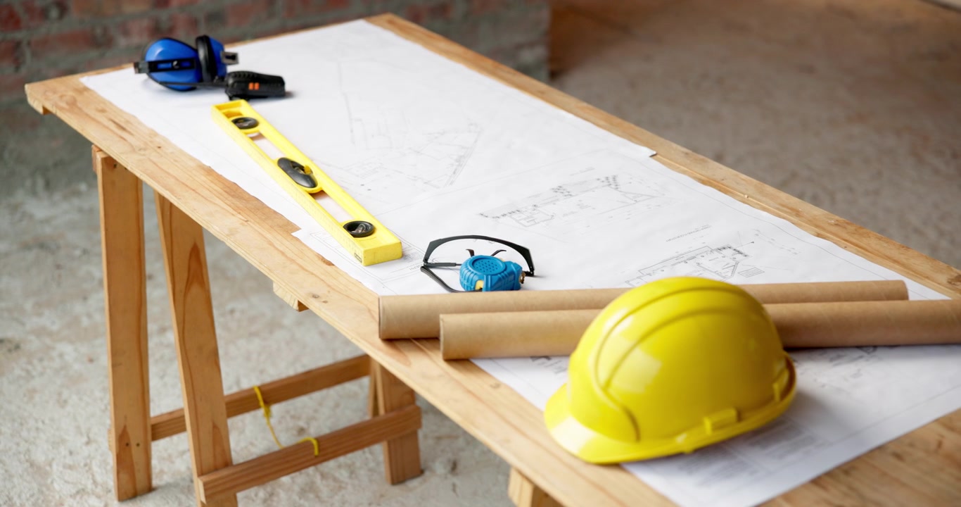 Construction Tools and Safety Gear on Blueprint Table
