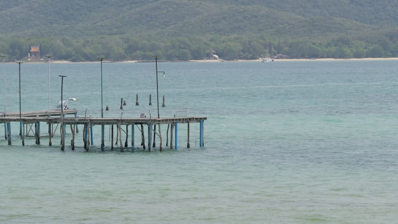 A tranquil pier scene evokes relaxation showcasing calm waters and lush surroundings.